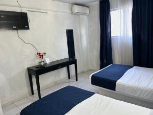 Ένα ή περισσότερα κρεβάτια σε δωμάτιο στο Hotel Independencia