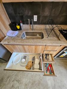 a kitchen with a sink and a counter top at Casa 09 - Villa Cotinguiba in Tatuamunha
