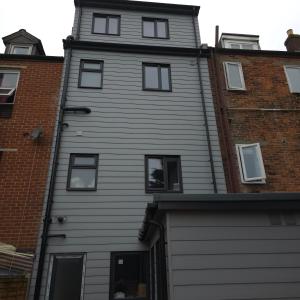 a gray house with windows and a garage at Bevois Valley Serviced Apartments - Comfort and Convenience in Southampton