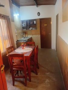a kitchen with a table and chairs in a room at Punto Descanso in Corrientes