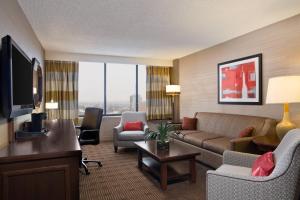 a living room with a couch and a tv at Sheraton Philadelphia University City Hotel in Philadelphia