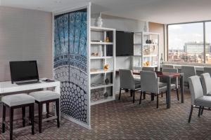 a conference room with a table and chairs and a television at Sheraton Philadelphia University City Hotel in Philadelphia