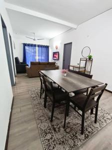 a dining room table and chairs in a living room at IRDINA HomestayMuslim's 2 at Emerald Avenue Brinchang Centrum in Brinchang +22 photos