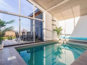 a house with a swimming pool and a dining room at 8 person holiday home in Væggerløse-By Traum in Marielyst