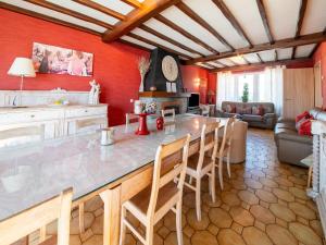 a kitchen and living room with red walls at Escape at Mont Saint Jacques in Trois-Ponts