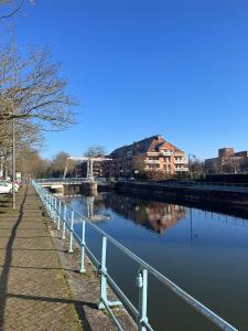 una passerella accanto a un fiume con un ponte di Au fil de l'eau, Gare, Wifi, TV, Parking a Douai