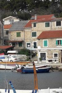 a group of boats docked in front of a building at Seaside holiday house Maslinica, Solta - 23838 in Grohote