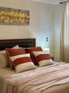 a bed with several pillows on top of it at Desconexión y Paz in Pucón