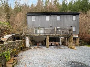 a large house with a deck and a patio at Charming Cottage by Semois in Vresse-sur-Semois