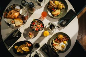 a table filled with different types of breakfast foods at Marriott Montreal Airport In-Terminal Hotel in Dorval