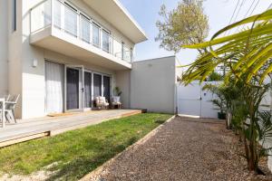a home with a large deck with a patio at Elwood Star- Beachside Retreat in Melbourne