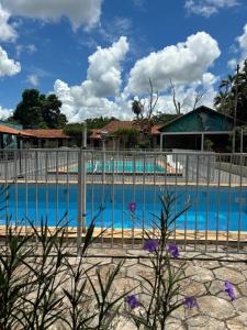 a fence next to a swimming pool at Pousada Cachoeira do Campo in Aquidauana +40 photos