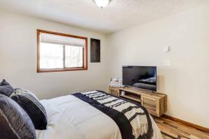 a bedroom with a bed and a flat screen tv at Chalet retreat in Tobyhanna in Tobyhanna +13 photos