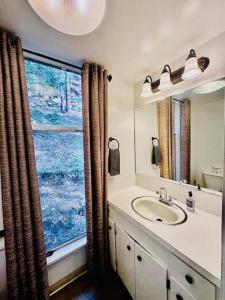 a bathroom with a sink and a large window at Views inside Yosemite-Timber Lodge-Sleeps 6 in Yosemite West