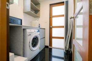 a laundry room with a washing machine in it at Luxurious Residence Rawai in Phuket