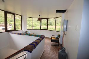a room with a hallway with windows and a table at Casa de Campo Apu San Isidro in Urubamba