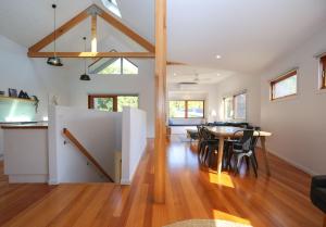 a dining room and living room with a table and chairs at The Stelvio Villas - One in Bright