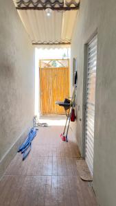 a room with a hallway with a door and a tiled floor at Canto do Mangue in Cascavel