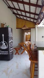 a dining room with a table and a refrigerator at Canto do Mangue in Cascavel