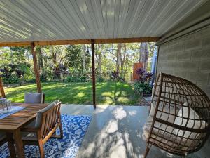 a screened in porch with a table and chairs at Mayers Cottage in Perwillowen