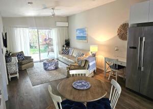 a living room with a table and a couch at Mayers Cottage in Perwillowen
