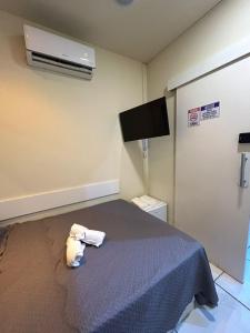 a bedroom with a bed with a stuffed animal on it at Cine Rio Hostel RJ in Rio de Janeiro