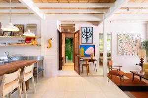 a kitchen with white walls and a counter with a table at Nest Bungalow - Pool Walking To The Beach in Santa Teresa Beach