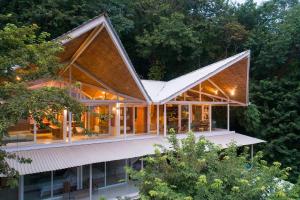 an image of a house with a large roof at Nido Del Mar - Art-filled Beach House in Santa Teresa