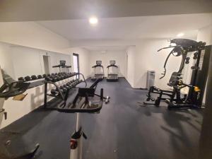 a gym with several tread machines in a room at Lujoso exclusivo próximo monumento in Santiago de los Caballeros