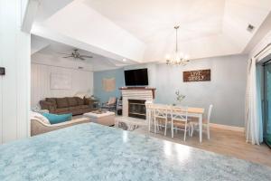 a living room with a couch and a dining room at Serene Duplex Lakefront Retreat: sleeps up to 20 in Rocky Mount