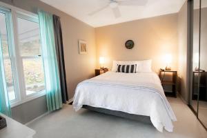 a bedroom with a bed and a large window at Serene Duplex Lakefront Retreat: sleeps up to 20 in Rocky Mount