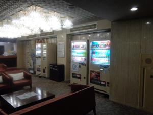 a living room with a couch and two video games at Hotel Il Viale Hachinohe in Hachinohe