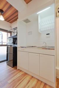 a kitchen with white cabinets and a sink at V Close to Kyodo sta 12 min to Shinjuku in Tokyo
