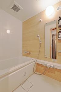 a bathroom with a bathtub and a mirror at V Close to Kyodo sta 12 min to Shinjuku in Tokyo