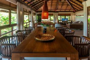 a pizza sitting on a wooden table in a restaurant at Extraordinary BaliStyle Villa in Bophut Hills with Prime Location in Bophut 