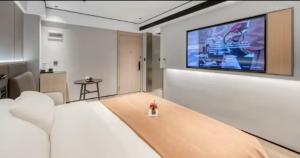 TV a/nebo společenská místnost v ubytování 龚禧里初见版纳店
