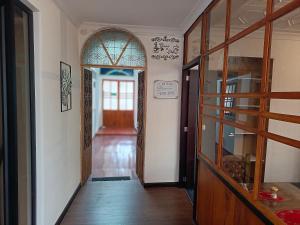 a hallway with an entry way with a glass door at Suite Colibrí - El Renacimiento Suites in Cuenca