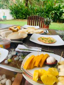 a table with plates of food on top of it at Chill House Udawalawa in Udawalawe