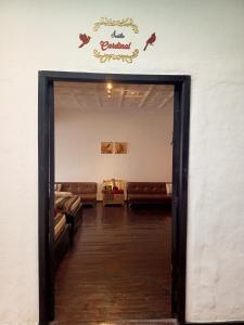 an open door to a waiting room with couches at El Renacimiento - Suite Cardinal in Cuenca