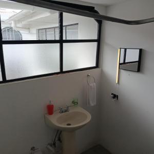 a bathroom with a sink and two windows at El Renacimiento - Suite Cardinal in Cuenca +14 photos