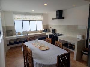 a kitchen with a table and chairs in a kitchen at Suite Cardinal - El Renacimiento Suites in Cuenca +14 photos