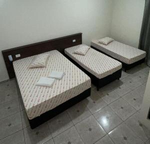 two twin beds in a room with at Hotel Patriarca in Sao Paulo