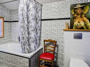 a bathroom with a tub and a picture of a woman at Grande Maison Familiale Rénovée à Froideterre - FR-1-583-374 in Froideterre +17 photos