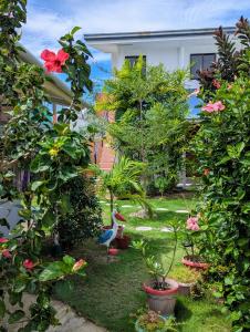 a garden with potted plants and a bird in the yard at Astillo's Guest Houses in Moalboal