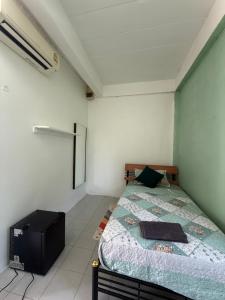 a bedroom with a bed and a tv in it at Happiness Hostel Private room in Phra Ae beach +4 photos