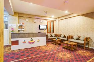 a waiting room with couches and a flat screen tv at Hotel The York in Noida