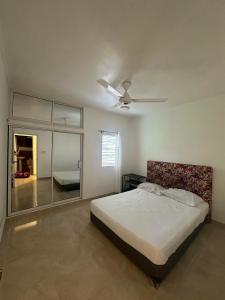 a bedroom with a bed and a ceiling fan at El Rincon de Luna in Constanza