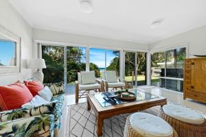 a living room with a couch and a table at Kirby's Berrara Beach House in Berrara