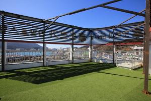 a large outdoor area with benches and a fence at Dorcas Tourist Hostel in Tongyeong