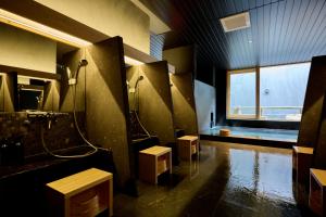 a large bathroom with a shower and a sink at Matsuya Bekkan in Kumamoto